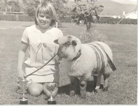 Girl (unidentified) with pet lamb, 2 cups & 3 ribbons - Resource cover image