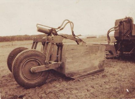 Hydraulically operated soil scraper / scoop towed by bulldozer