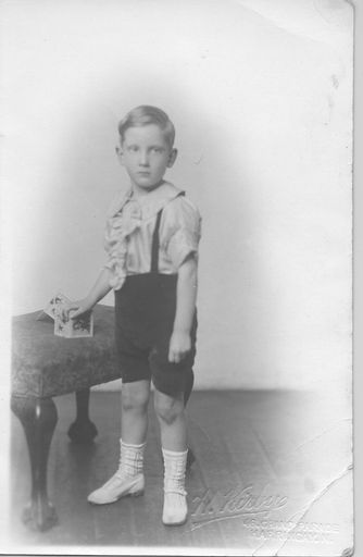 Boy with frilly shirt and white lace socks. - Resource cover image