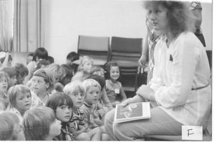 Children sitting on floor being talked to