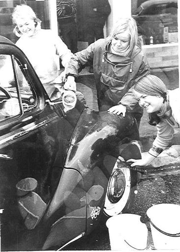 Three Young Women Washing A Car