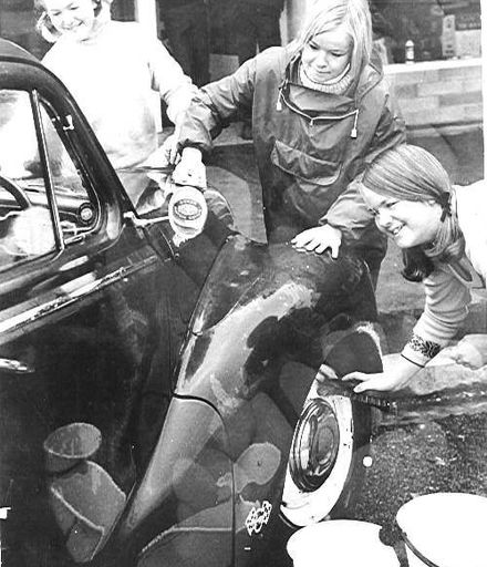 Three Young Women Washing  A Car