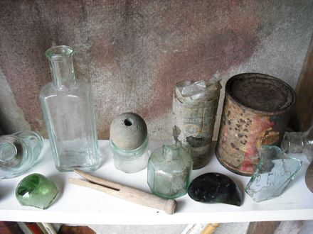 old peg and tins and bottles