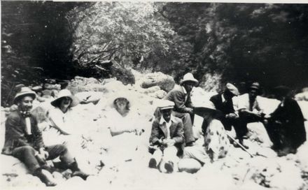 Group (unidentified) of 6 men & 3 women sitting on rocks by stream, c.1930's