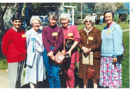 Group of female ex staff looking around the school grounds
