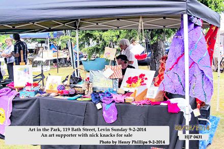 HJP 0431      Art in the Park, 119 Bath Street, Levin Sunday 9-2-2014  An art supporter with nick knacks for sale - Resource cover image