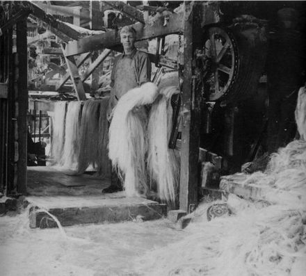 Man Holding Hunk of Scutched Flax Fibre
