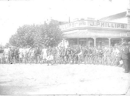 Group of Cyclists Outside Byko Shop