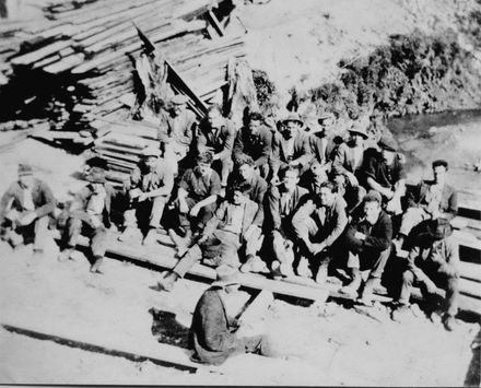 Large group of men sitting on stacks of sawn timber, c.1920's