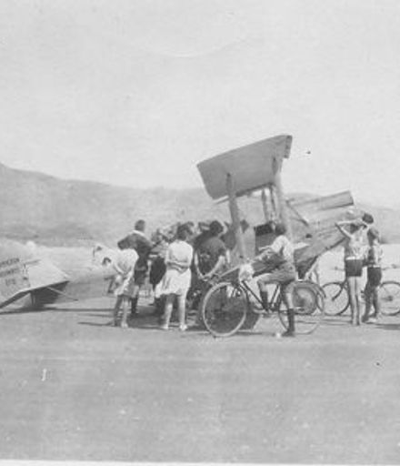 Bi-plane belonging to Hamilton Airways Ltd surrounded by people, 1927 or 1928