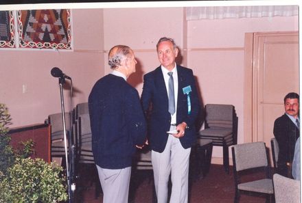 George Dowd congratulating John Goodwin on writing the school's history