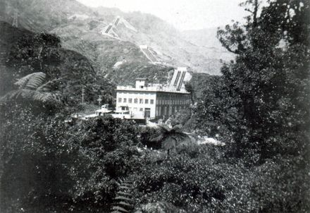 View of Mangaore Powerhouse through bush with penstocks in background, c.1923-24 (?)