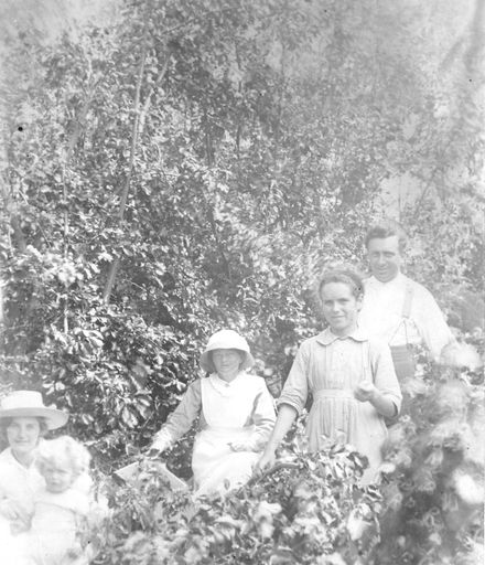 Five people in garden (berry picking ?)