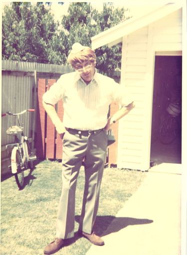 Man (unidentified) standing on grass in front of garage, c.1979