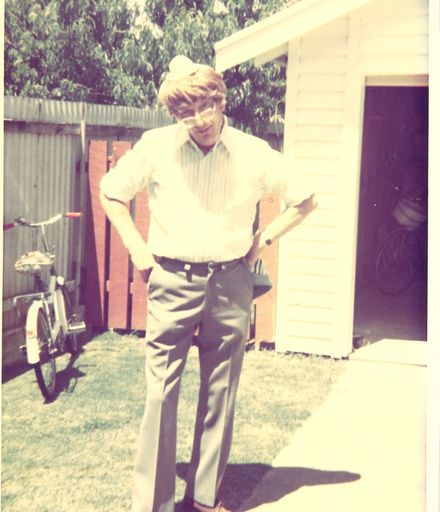 Man (unidentified) standing on grass in front of garage, c.1979