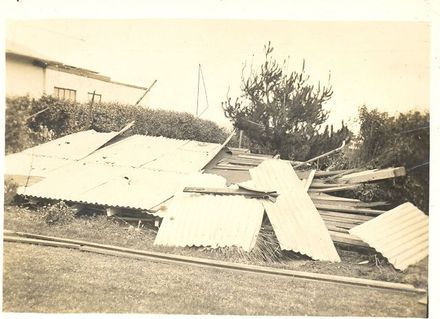 Roof blown off Shannon house (background) during storm, 1936