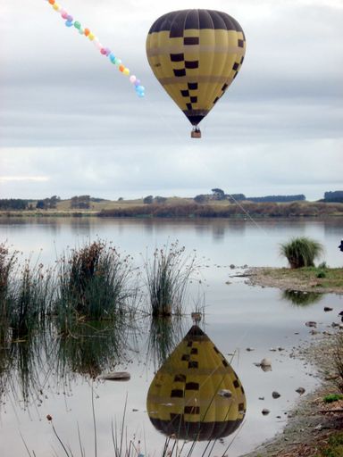 Yellow and Black balloon reflected in Lake Horowhenua