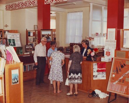 Interior of Otaki Library showing borrowers at issues desk, 1981