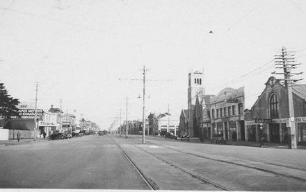 Another view of main street with double tram-lines in unidentified city, 1927 or 1928
