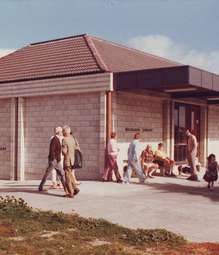 Exterior of Waikanae Library with groups of unidentified people, 1981