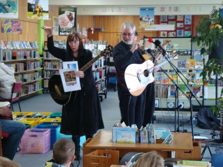 Singer showing picture to childres