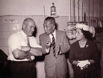 Factory tour - two men and a woman (right)