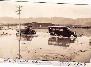 Commerce bus being towed out of floodwater by Thornycroft bus, July 1926