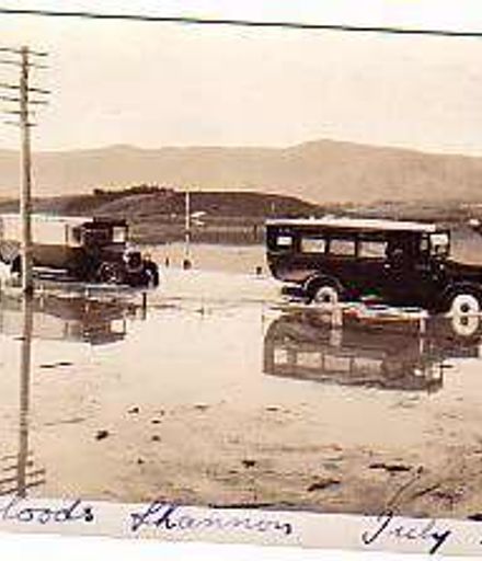 Commerce bus being towed out of floodwater by Thornycroft bus, July 1926