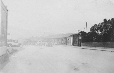 Outside unidentified railway station, 1927 or 1928
