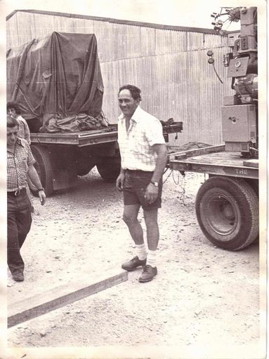 Wilf Lincoln standing beside truck loaded with new machinery for Lane's