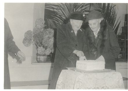 Mrs Rose, Mrs Simcox jointly cutting cake - Resource cover image