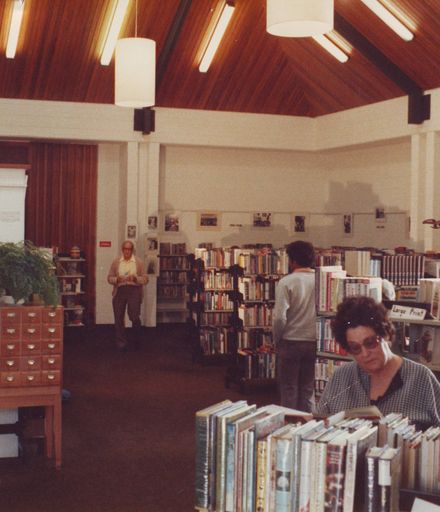 Interior of Waikanae Library showing 2 men & 1 woman, 1981