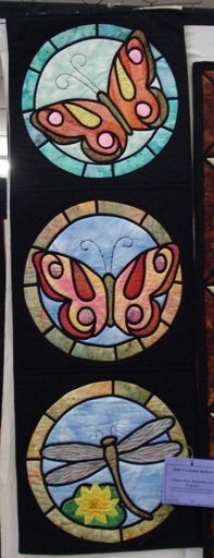 Stained glass butterflies and dragonfly