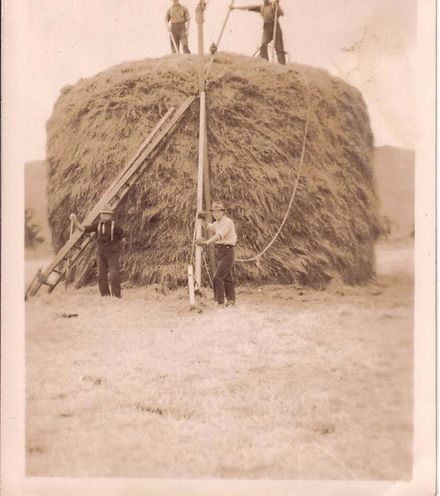 Men building haystack