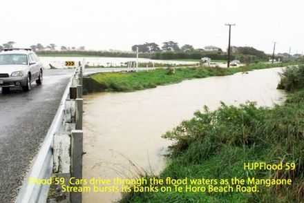 Flood 59  Cars drive through the flood waters as the Mangaone Stream bursts its banks on Te Horo Beach Road.