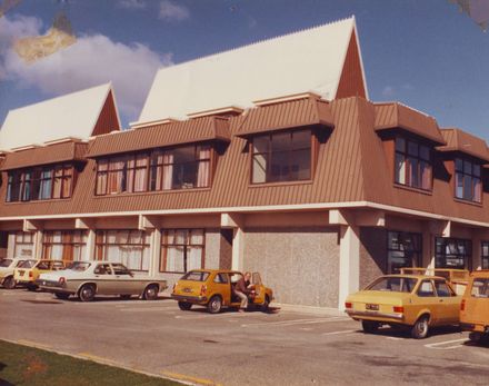 Exterior of Waikanae (? or Paraparaumu) Library showing car parking at rear, 1981