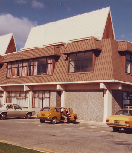 Exterior of Waikanae (? or Paraparaumu) Library showing car parking at rear, 1981