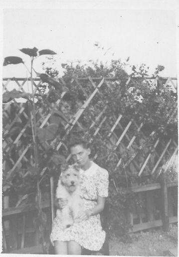 Lady in flowered dress with dog. - Resource cover image