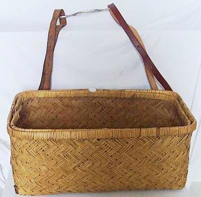 Wicker dress basket with lid and straps.
