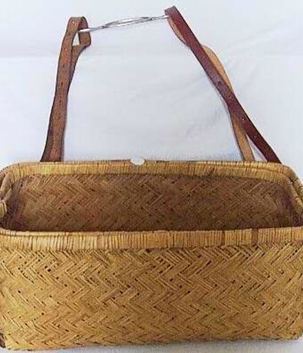 Wicker dress basket with lid and straps.