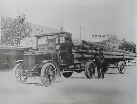 Thornycroft truck with load of wooden power poles, c.1923