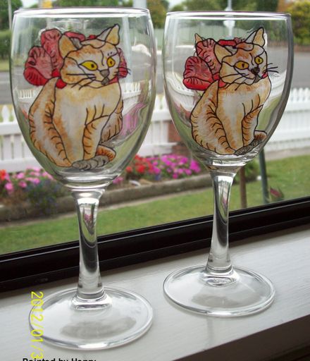 White cat with red ribbon wine glasses