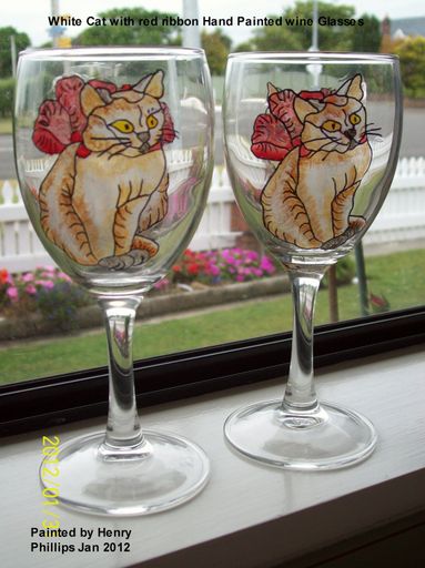 White cat with red ribbon wine glasses