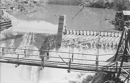 Flood spilling over incomplete dam, Mangahao, 1924