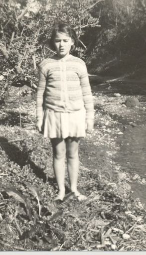 Young Girl standing beside stream