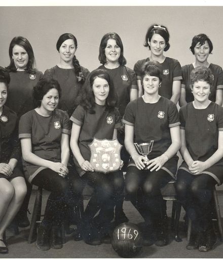 Rahui women's netball team with cup & shield, 1969