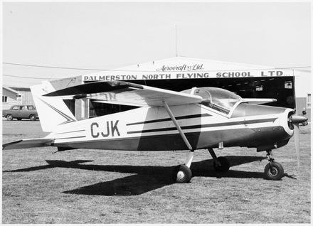 CJK Bolkow aircraft in front of the Palmerston North Flying school building