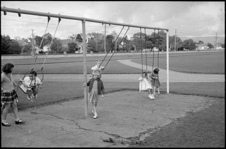 Children enjoying the playground swings